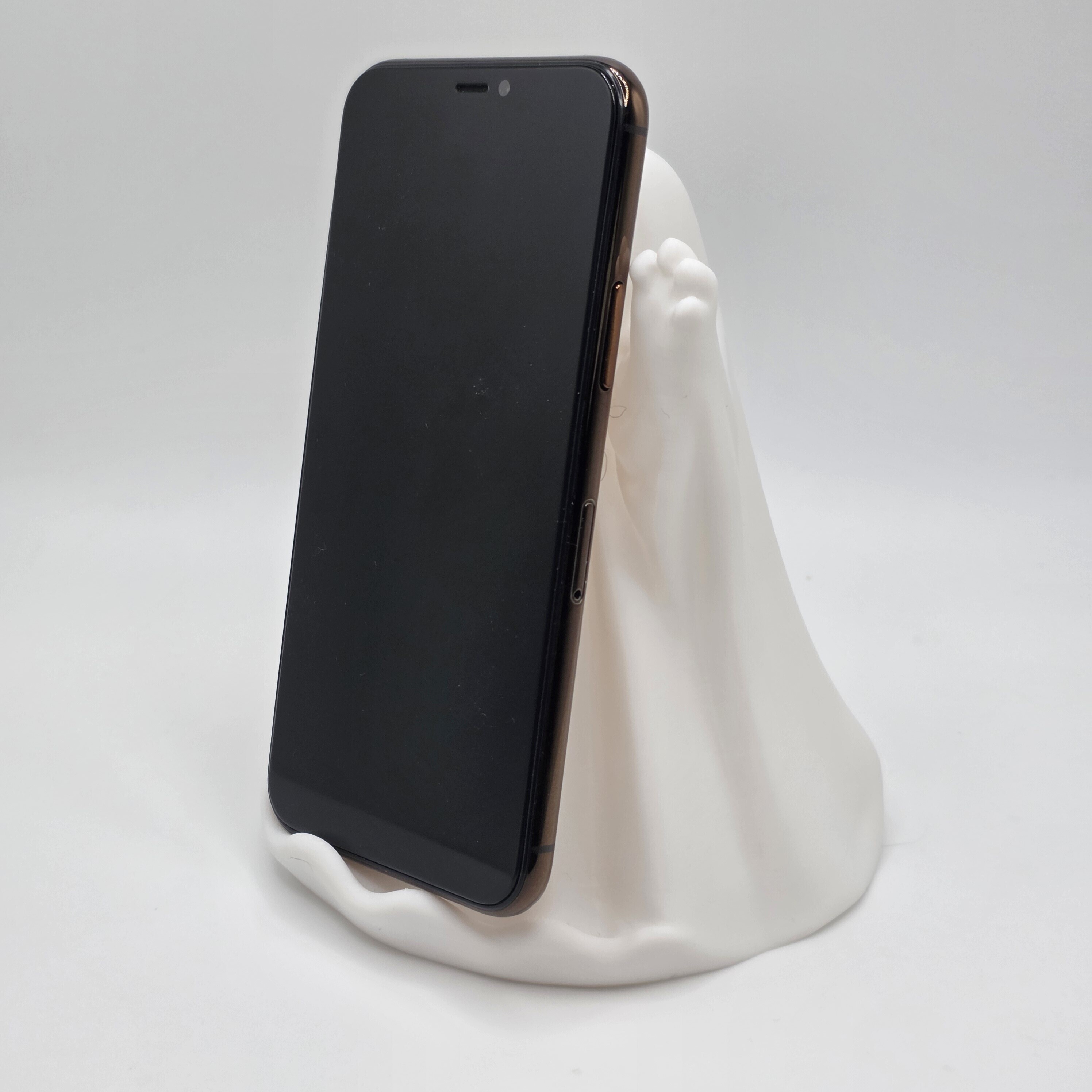 Photograph of the printed ghost phone stand holding a phone